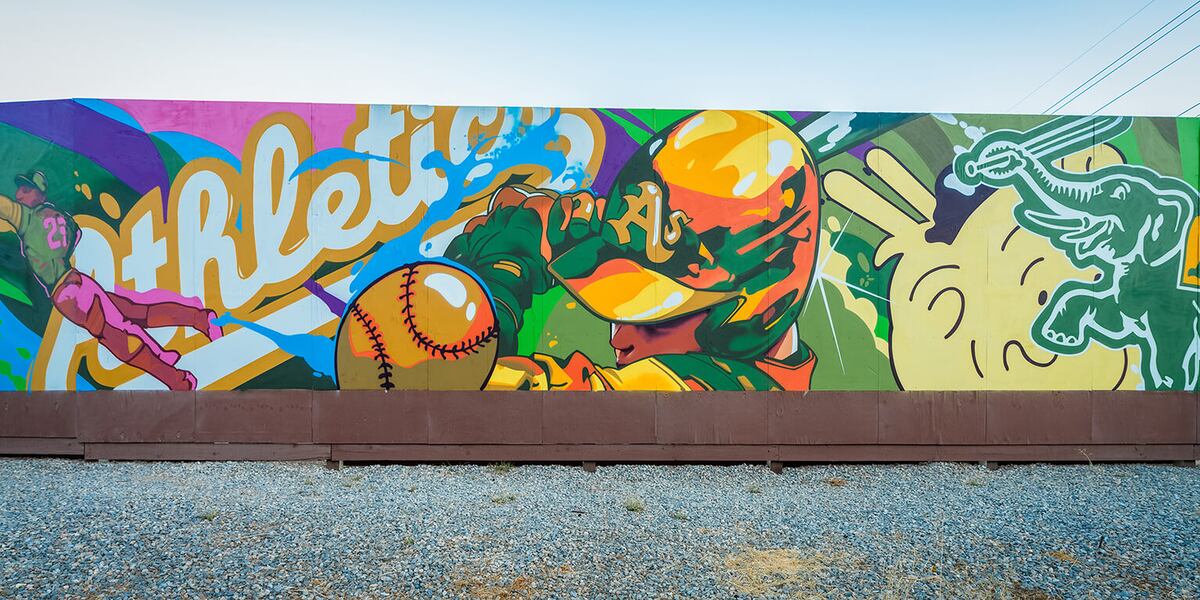 A colorful mural featuring a baseball player and a dinosaur