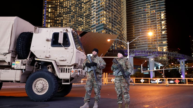 Members of the Nevada National Guard stand at a roadblock on a road leading to the Las Vegas...