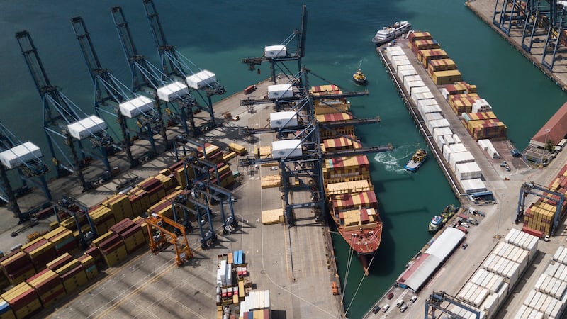 Cranes load and unload containers from cargo ships at the Cristobal port, operated by the...