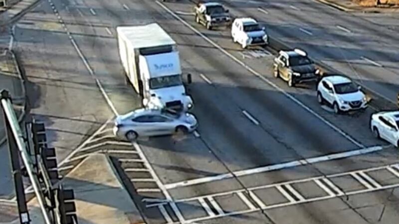 When the car reached Venture Parkway, a truck driver tried to change lanes to the right and...
