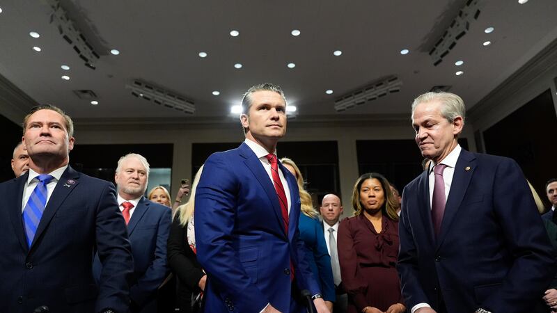 Pete Hegseth, center, President-elect Donald Trump's choice to be Defense secretary, appears...