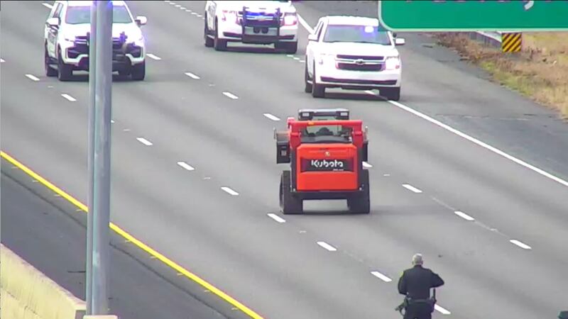 People who saw the bright orange track skid loader with police hot on its tail said it was a...