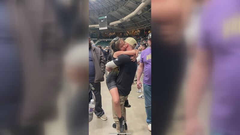 Laney Henning hugs her dad Shelby after winning her second straight wrestling championship.