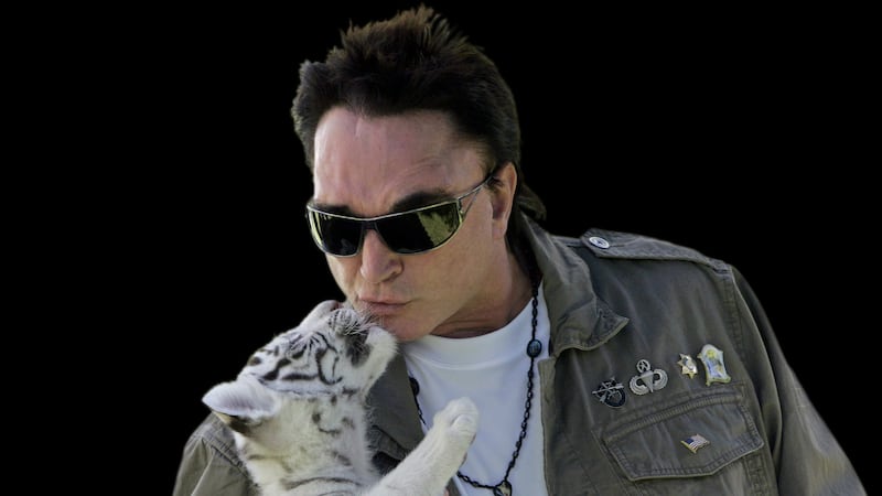 Roy Horn, of the  Siegfried and Roy magic show, kisses a white-striped tiger cub