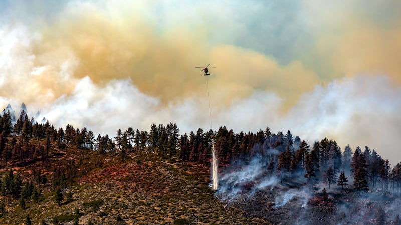 Scott Bartolomeo provided this photograph of a helicopter dropping water on the Davis Fire.