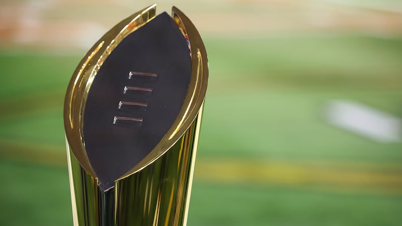 FILE - The College Football Playoff National Championship Trophy is shown before the Cotton...