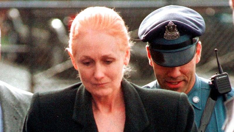 FILE - In this Nov. 8, 1999 file photo, Margaret Rudin is escorted by police into Framingham...