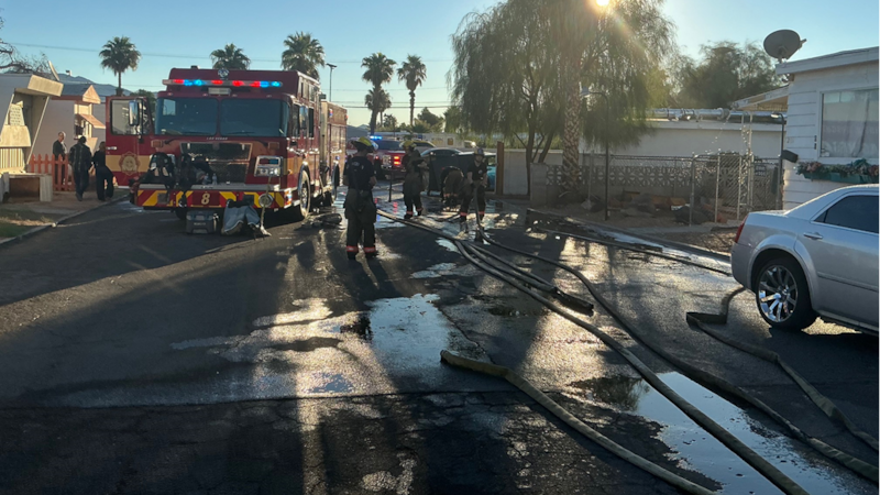 Firefighters battle mobile home fire that threatened neighboring home