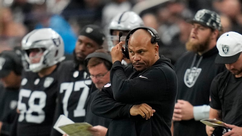 Las Vegas Raiders head coach Antonio Pierce watches during the second half of an NFL football...
