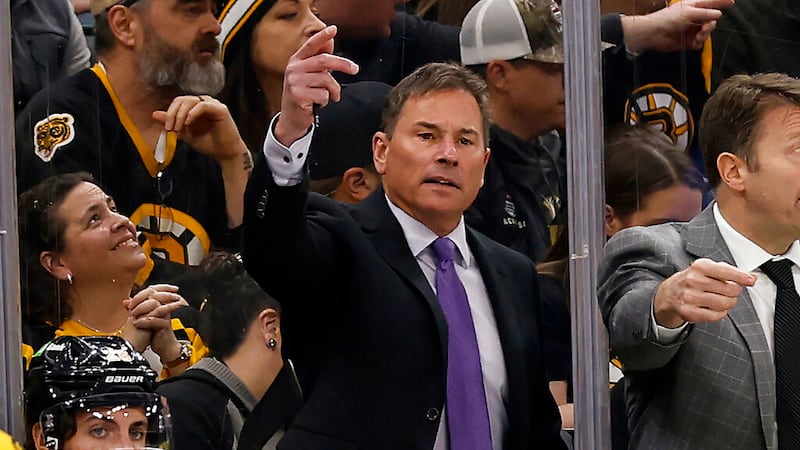 FILE -Boston Bruins head coach Bruce Cassidy, center, gestures during the third period of an...