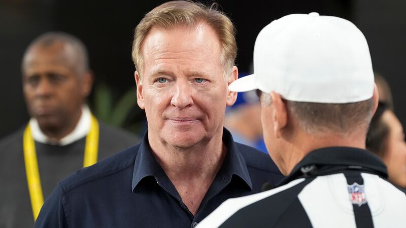 NFL Commissioner Roger Goodell, left, talks with Referee John Hussey before an NFL wild card...