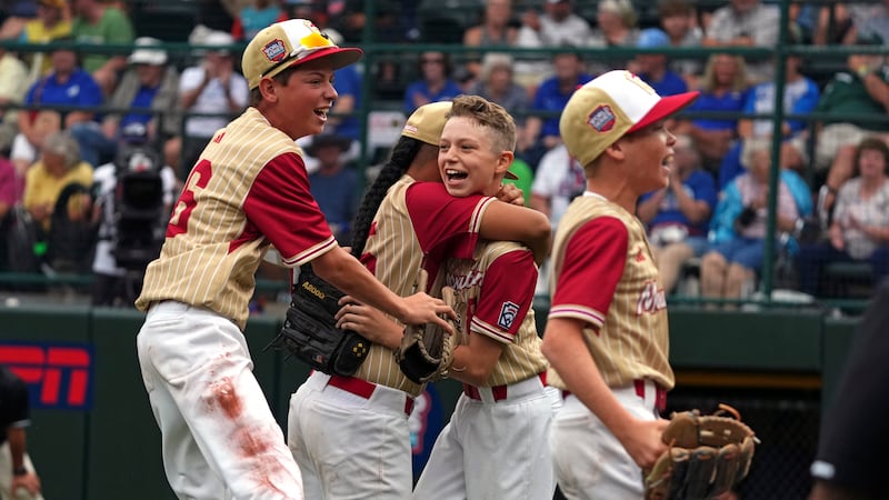 Henderson, Nev.'s Gunnar Gaudin, center right, celebrates with Noah Letalu, center left,...