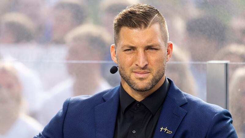 FILE - Tim Tebow listens to his co-hosts of SEC Nation during a broadcast in Lexington, Ky.,...