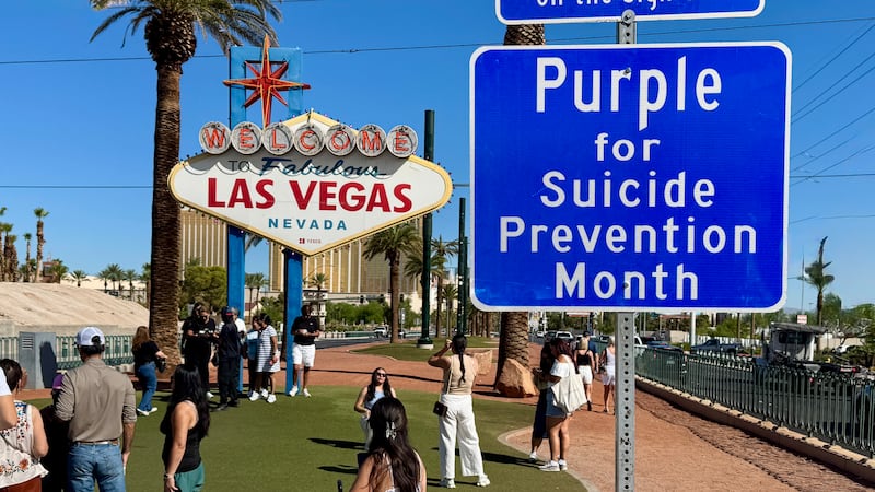 The Welcome to Las Vegas sign turns turquoise and purple for World Suicide Prevention Day on...