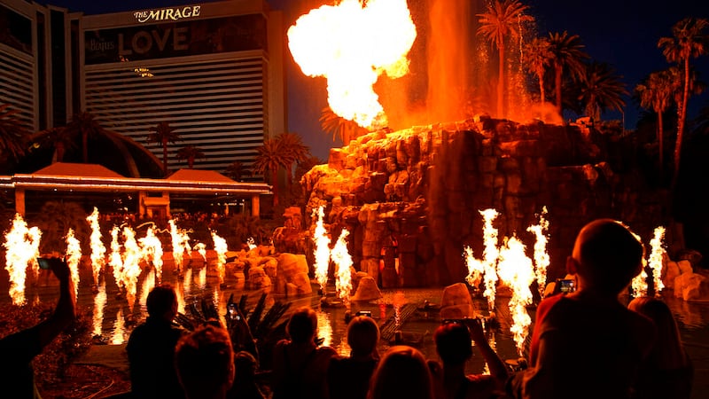 People watch the Volcano show at the Mirage hotel-casino along the Las Vegas Strip, Friday,...