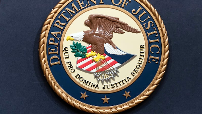 FILE - The Department of Justice seal is seen during a news conference at the DOJ office in...