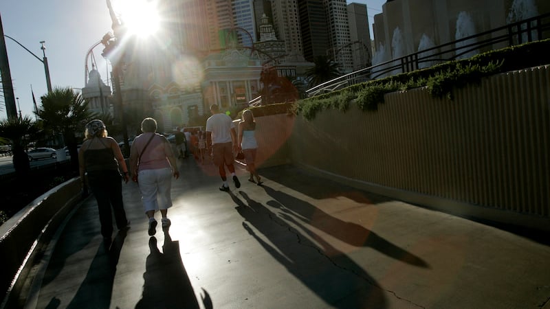 Tourists walk in harsh afternoon sunlight in Las Vegas, Tuesday, July 3 , 2007. The National...