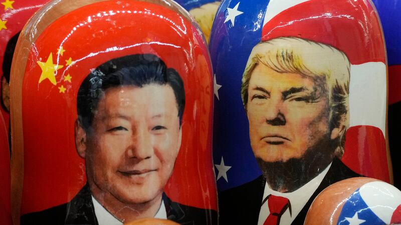 FILE - Traditional Russian wooden dolls called Matryoshka depicting China's President Xi...