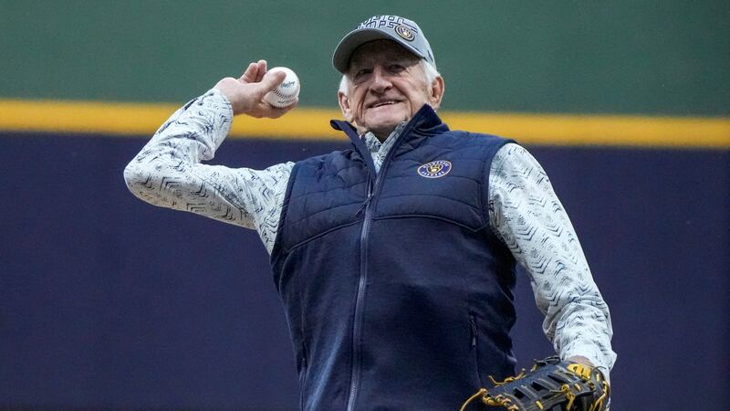 FILE - Bob Uecker throws the ceremonial first pitch before a Game 1 of the National League...