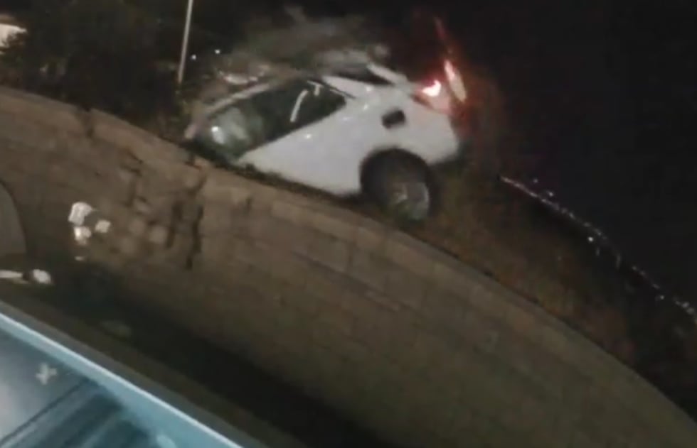 Surveillance video captures the shocking moment a car flies through the air before the driver...