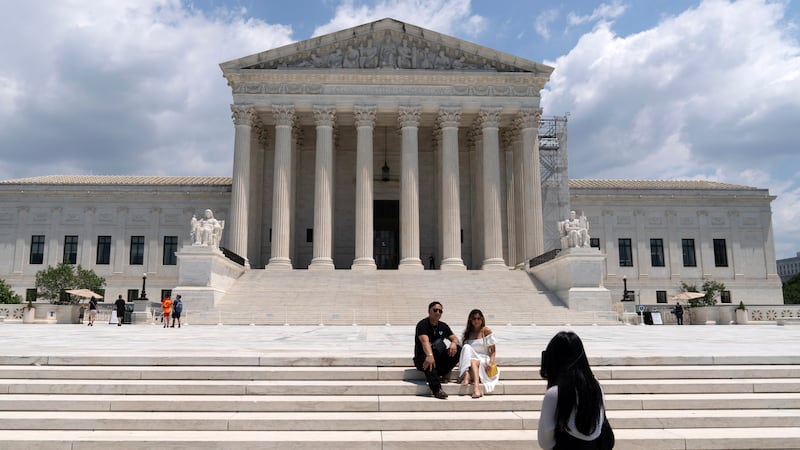 Visitors pose for photographs outside the U.S. Supreme Court Tuesday, June 18, 2024, in...