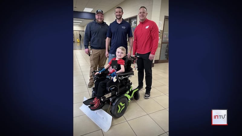 Wisconsin boy uses wheelchair to become a big help around his school