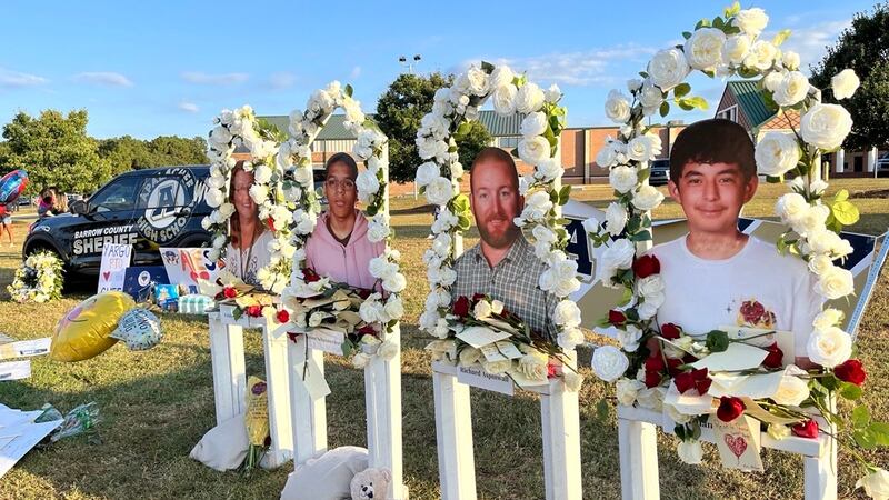 Under the flagpole at Apalachee High, a makeshift memorial has been setup for Christian...