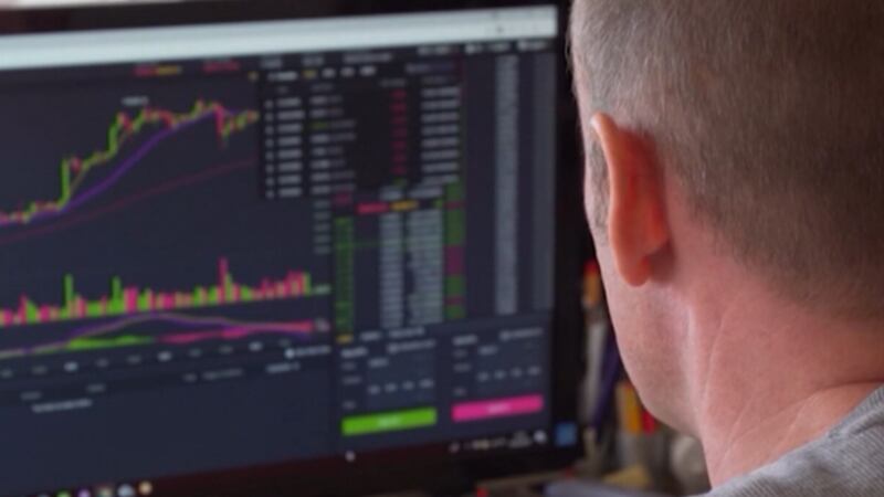 Person in front of computer with securities chart