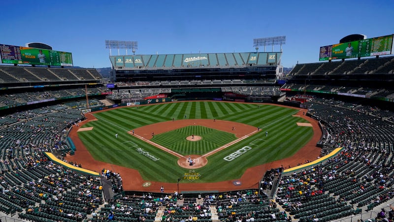 FILE - Fans at RingCentral Coliseum watch a baseball game between the Oakland Athletics and...