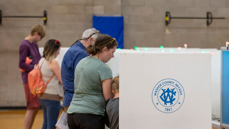 FILE - Voters cast their ballots in the Nevada primary election in Reno, Nev., June 14, 2022....