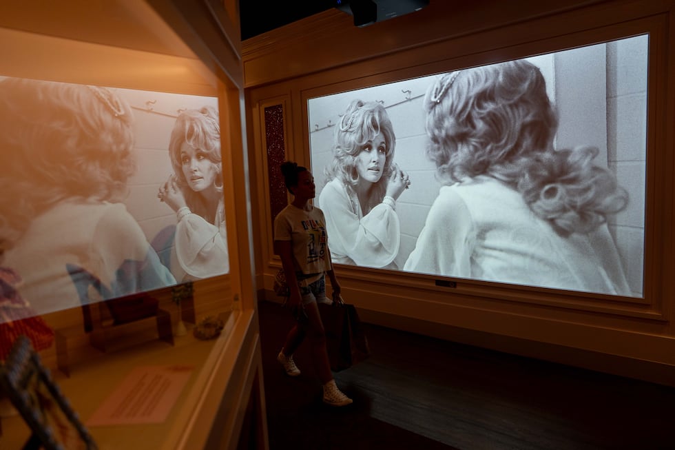 A visitor walks through a Dolly Parton exhibit at the Dollywood theme park in Pigeon Forge,...