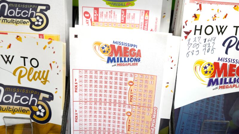 FILE - A stack of Mega Millions lottery play slips is displayed among play slips and...