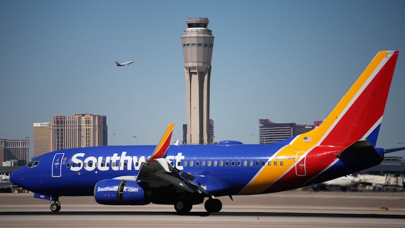 Planes land and take off at Harry Reid International Airport, Tuesday, Oct. 7, 2025, in Las...