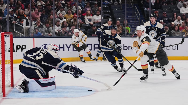 Vegas Golden Knights center Jack Eichel (9) attempts a shot as Columbus Blue Jackets...