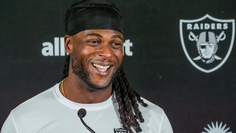 FILE - Las Vegas Raiders wide receiver Davante Adams (17) takes questions from the media after...