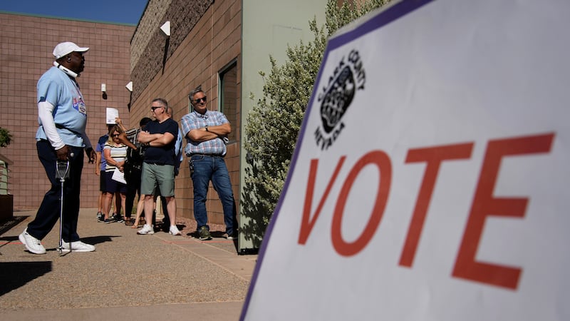People wait in line to vote at a polling place on June 14, 2022, in Las Vegas. The Nevada...